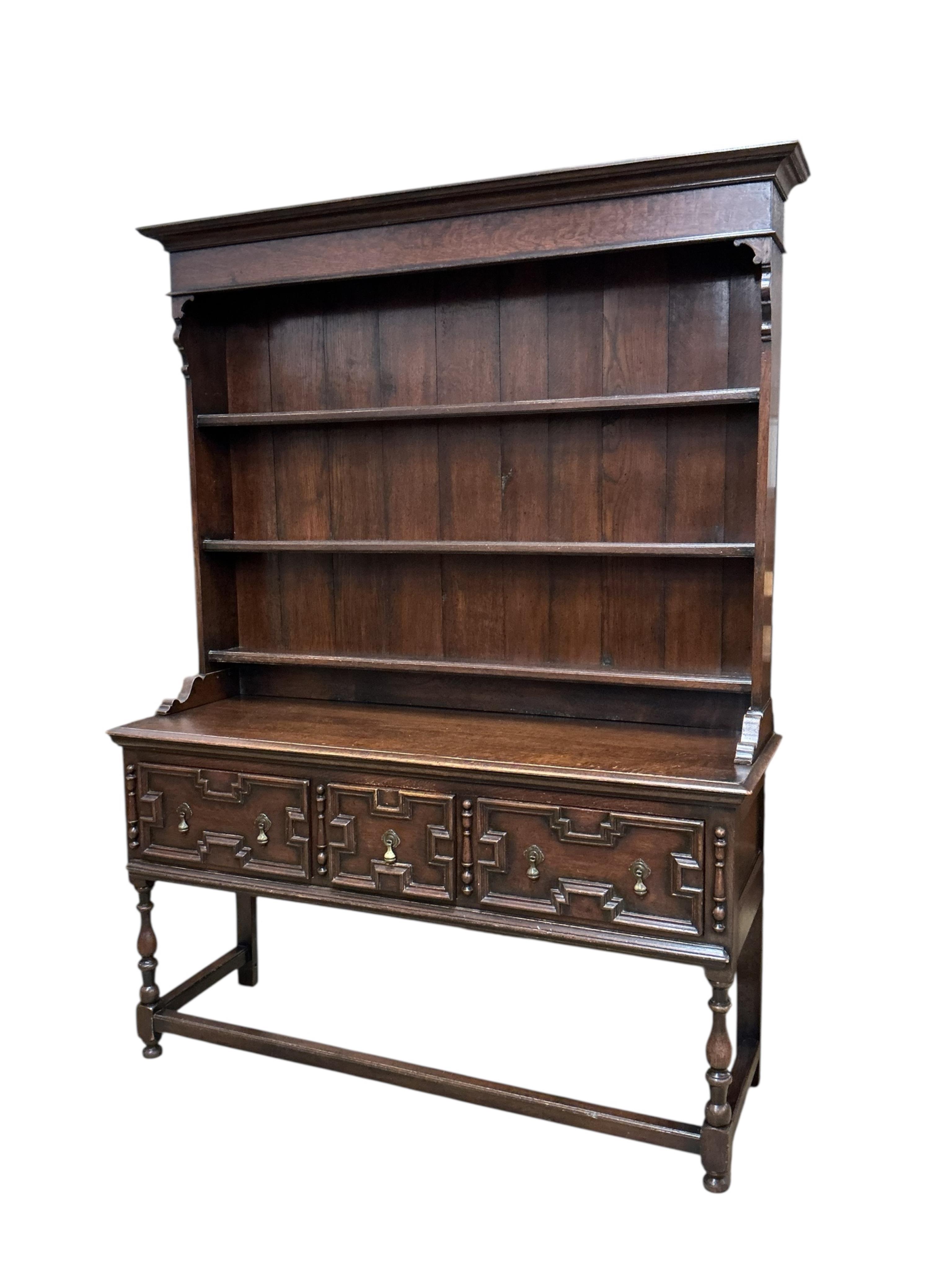 An early 20th century Jacobean Revival oak dresser with boarded rack, width 152cm, depth 51cm, height 206cm